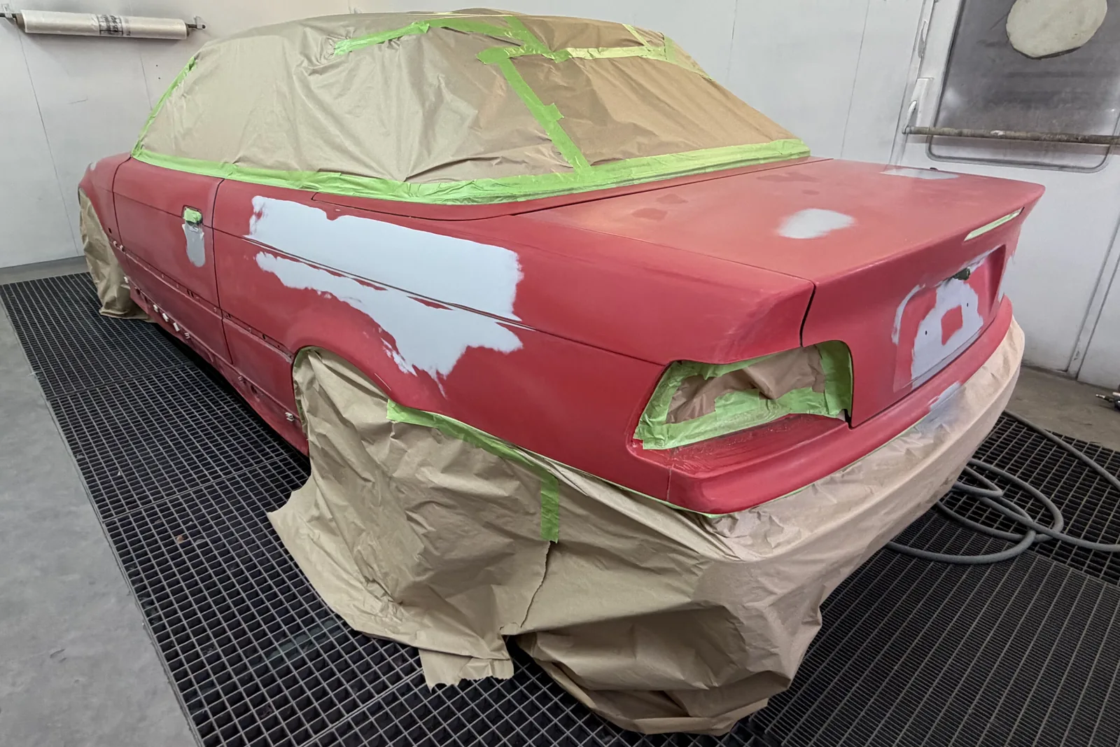 Avant : la même BMW en préparation dans la cabine de peinture